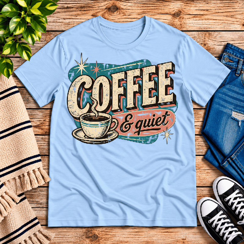 Coffee & Quiet Premium T-Shirt in baby blue, flat lay with retro coffee cup and starburst graphic