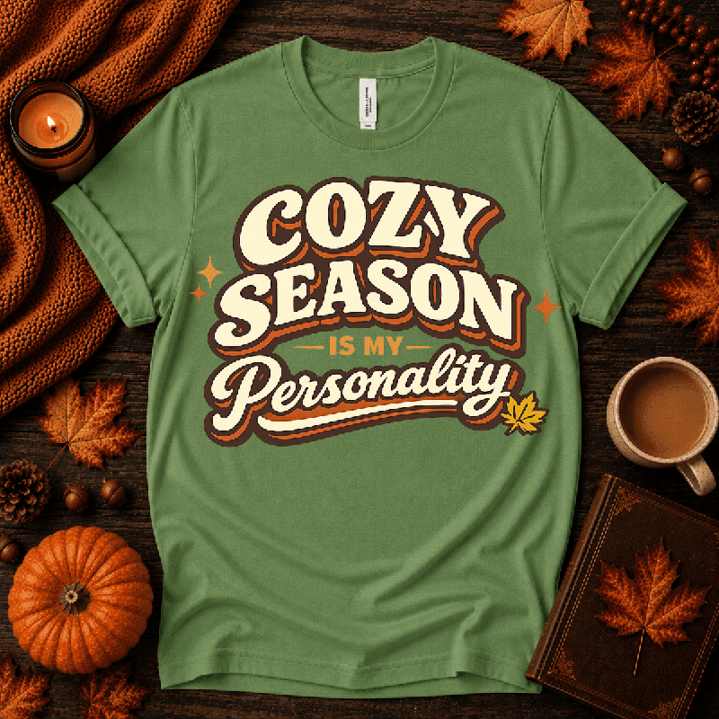 Cozy Season Premium T-Shirt in leaf sage green, flat lay with fall props