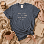 Too Much introvert graphic t-shirt cozy flat lay in dark heather.