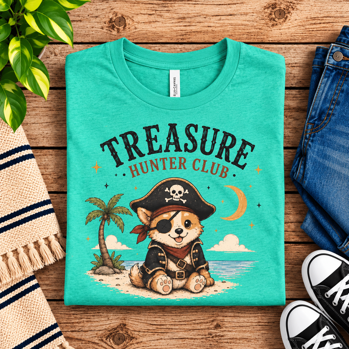 A folded mockup of Treasure Hunter Club cute animal graphic t-shirt in heather sea green.