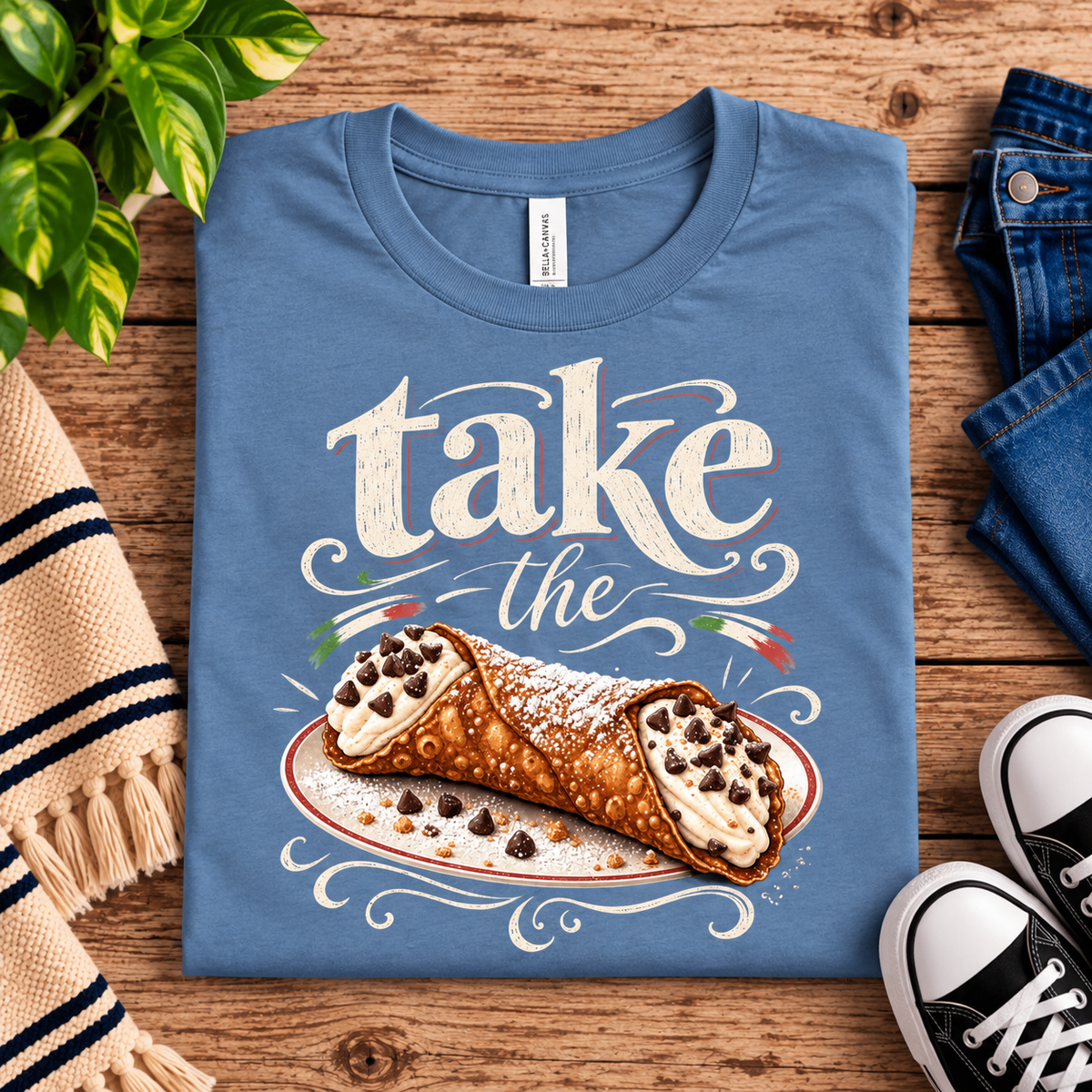 A folded mockup of Cannoli funny food graphic t-shirt in steel blue.