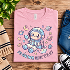 A folded mockup of Floating In Space funny introvert graphic t-shirt in pink.