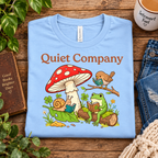 A folded mockup of Quiet Company cute cottagecore graphic t-shirt in baby blue.
