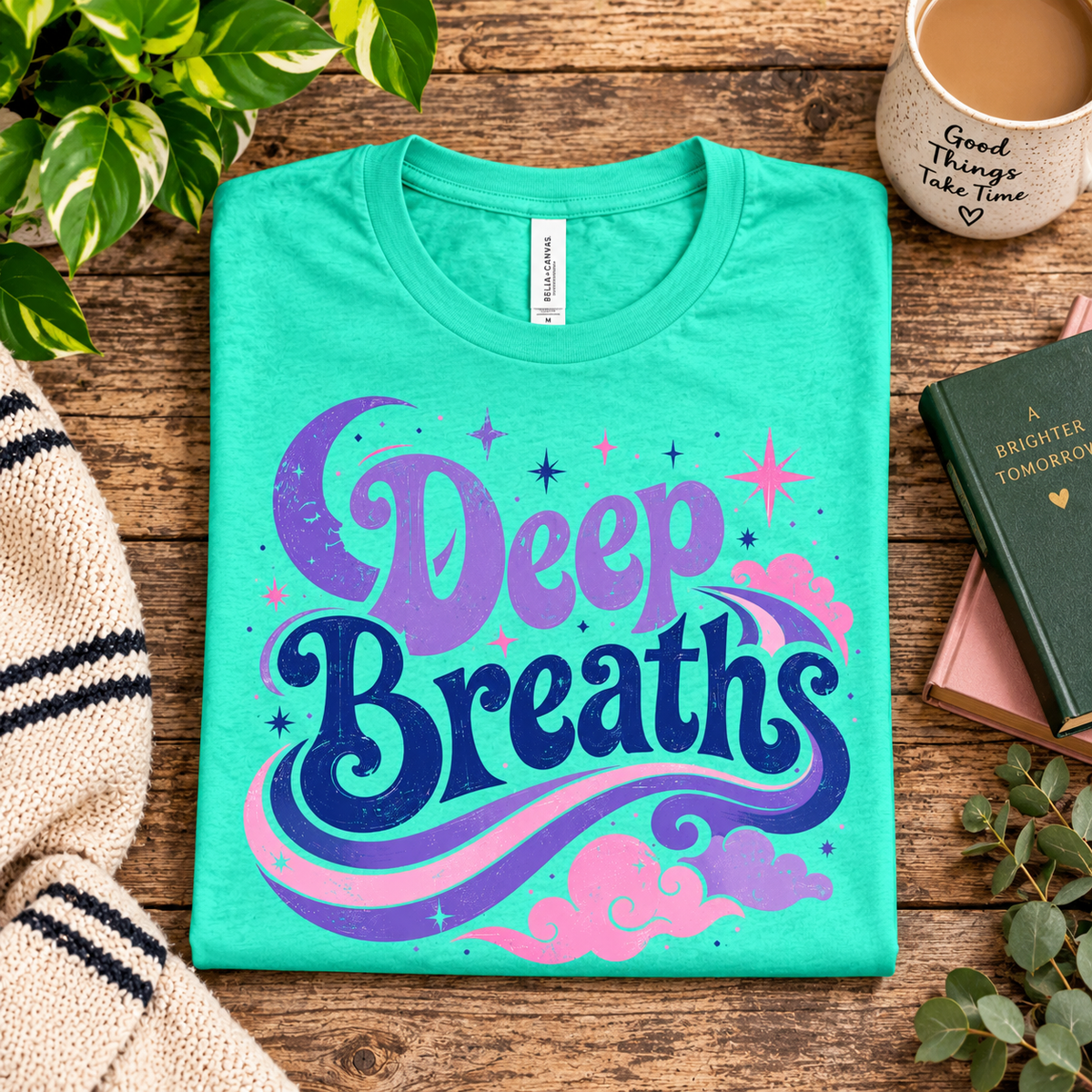 A folded mockup of Deep Breaths inspirational introvert graphic t-shirt in heather sea green.