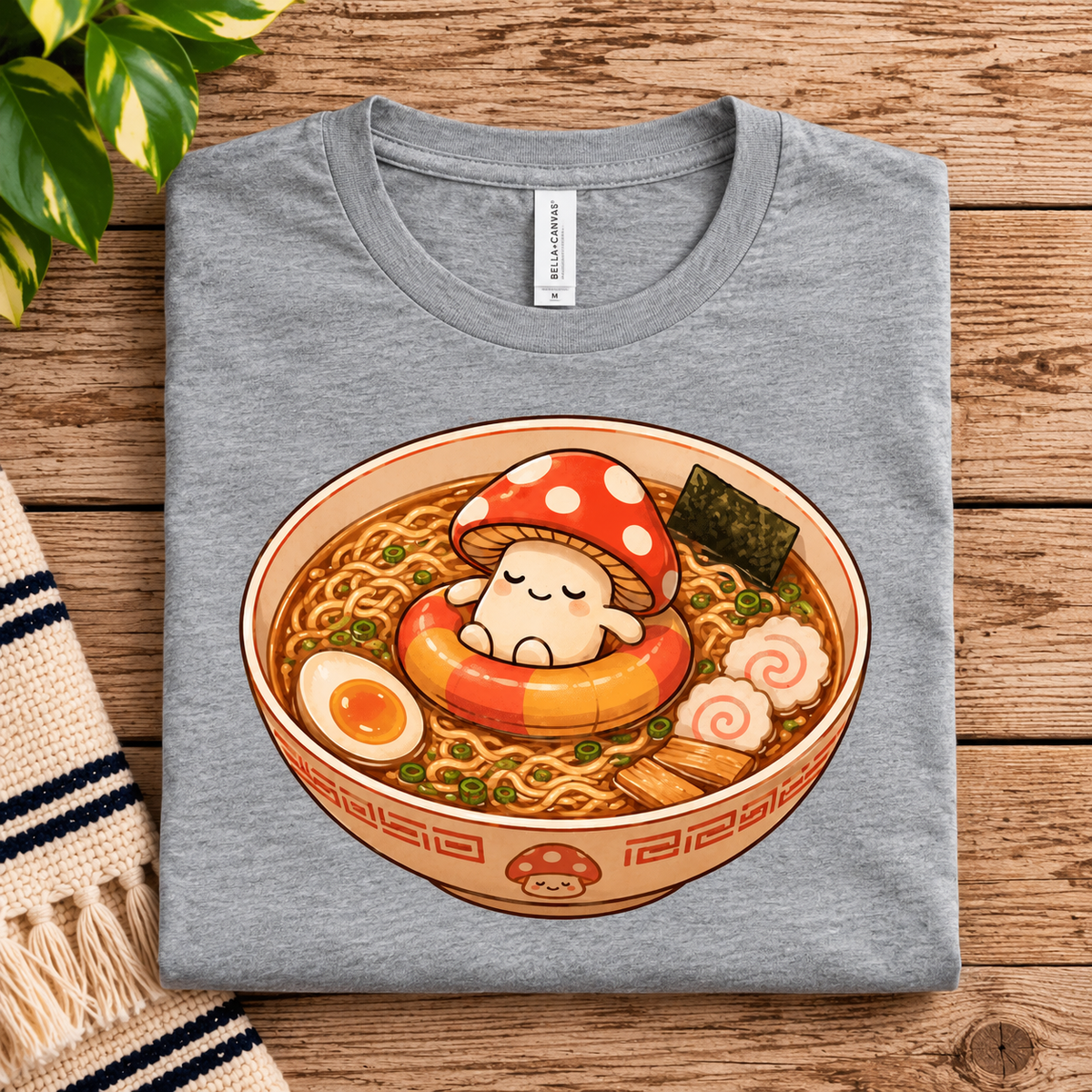 A folded mockup of Mushroom Float cute food graphic t-shirt in athletic heather.