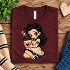 A folded mockup of Coffee Clara cute pinup graphic t-shirt in maroon.