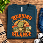A folded mockup of Running on Silence cute animal graphic t-shirt in deep teal.
