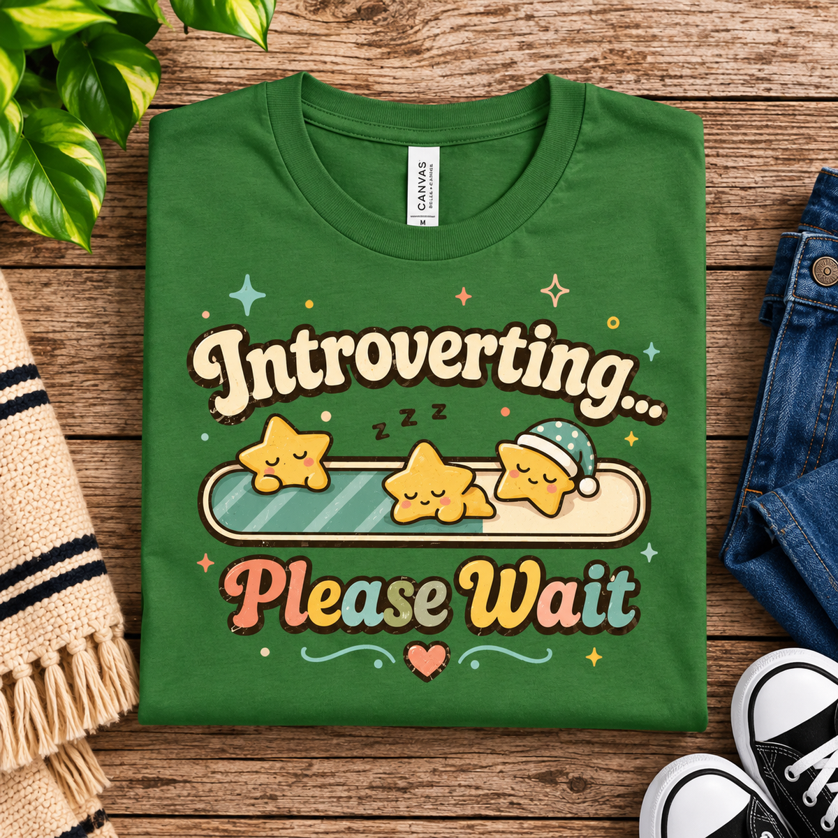 A folded mockup of Introverting... Please Wait cute kawaii graphic t-shirt in leaf.