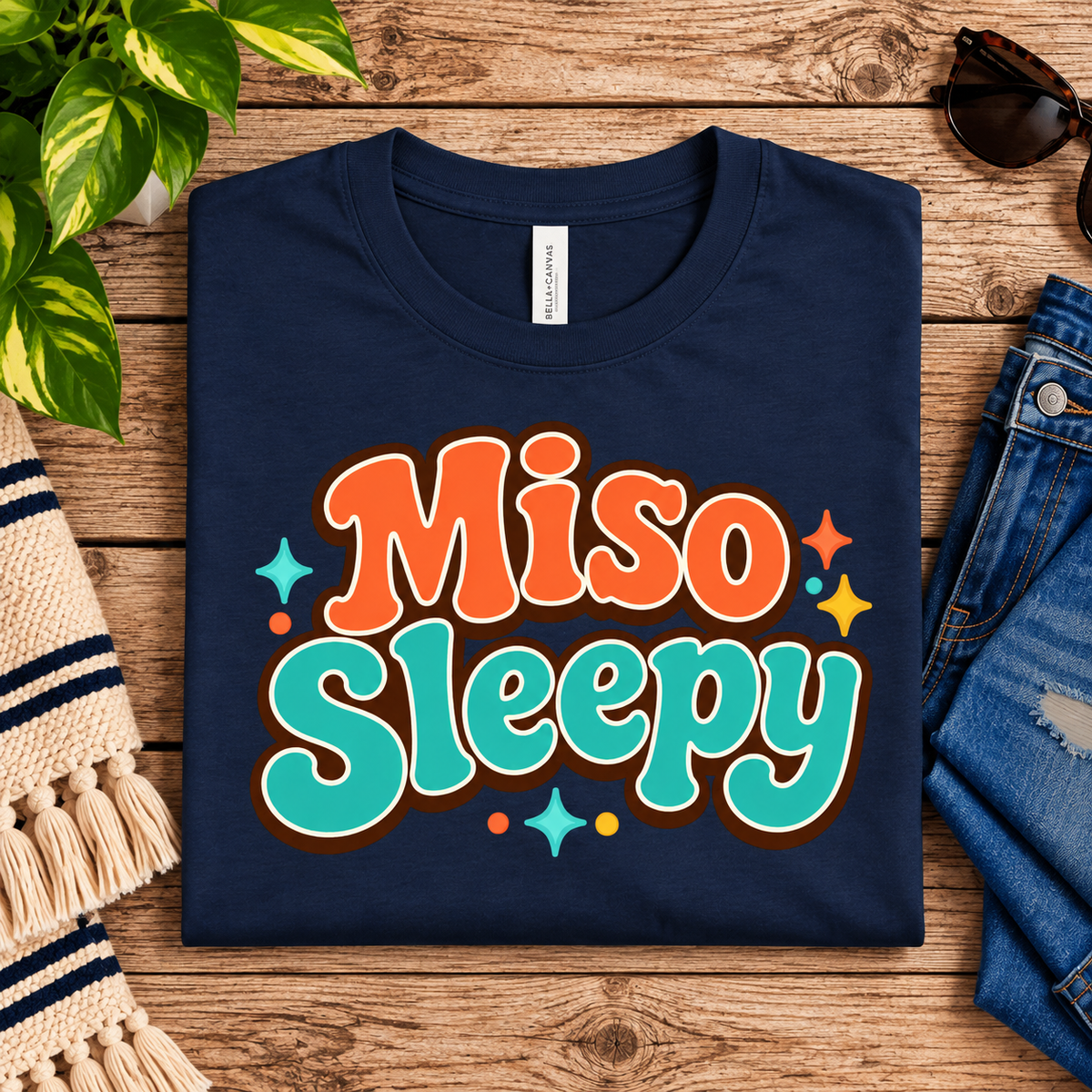 A folded mockup of Miso Sleepy funny food graphic t-shirt in navy.