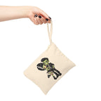 Close-up of a hand holding the Frankie & Frannie Accessory Pouch, showing the groom carrying the bride in chibi Frankenstein style