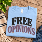 Free Opinions Premium T-Shirt in baby blue, folded close-up with neck tag showing