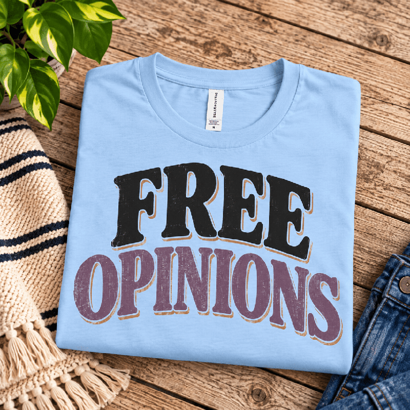 Free Opinions Premium T-Shirt in baby blue, folded close-up with neck tag showing