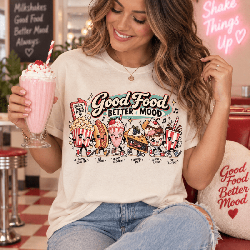 Woman holding a milkshake in a diner, wearing the Good Food Premium T-Shirt in vintage white