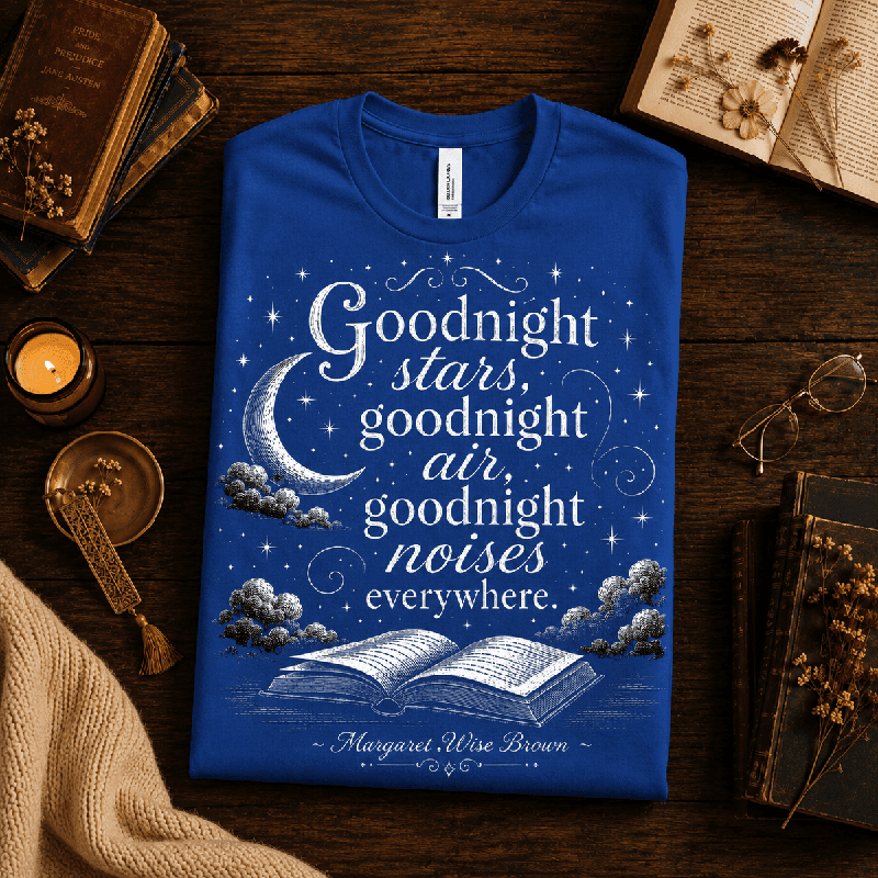 Goodnight Stars Premium T-Shirt in true royal blue, folded close-up styled with books and a candle