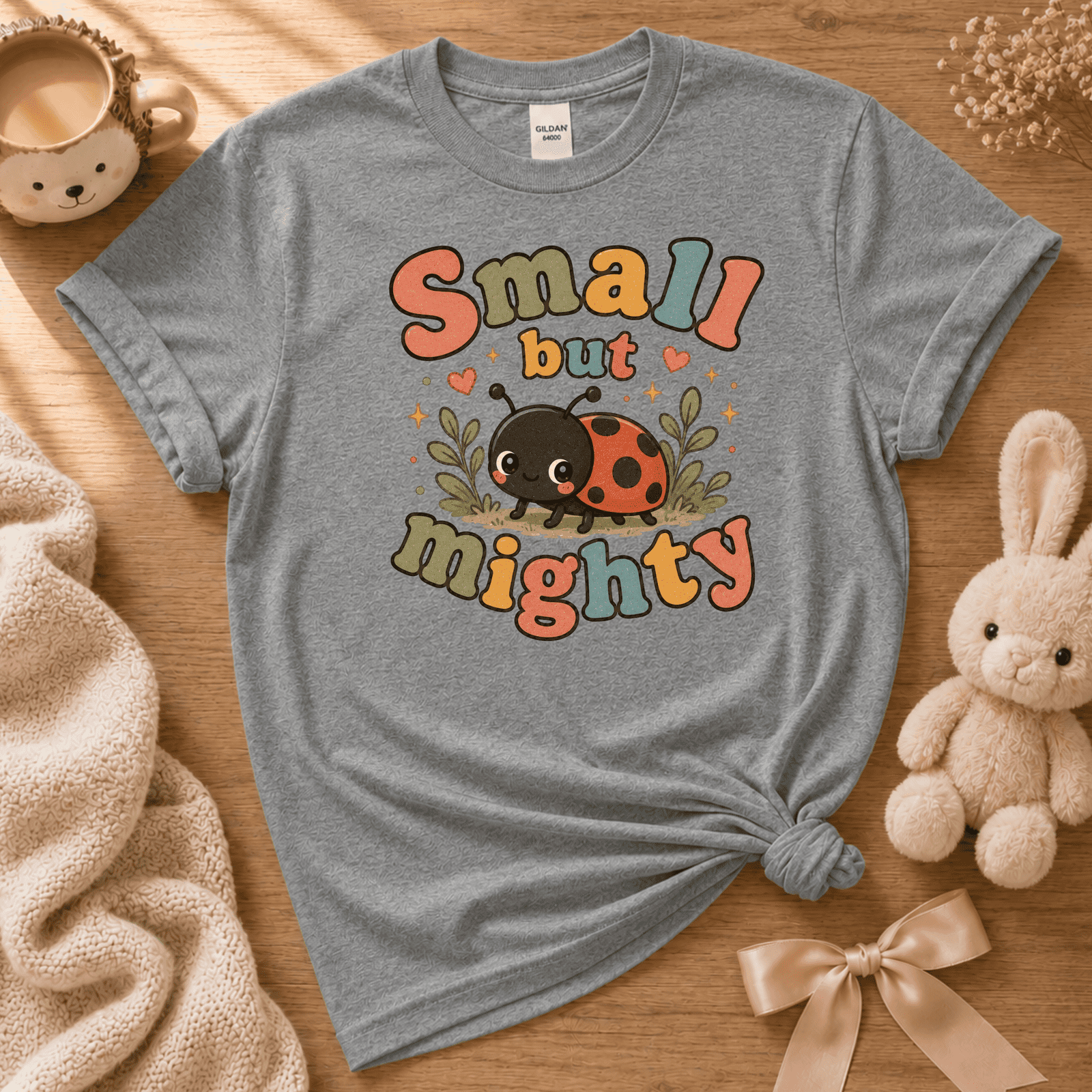 Small But Mighty cute animal graphic t-shirt cozy flat lay in graphite heather.