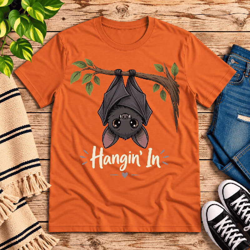 Hangin' In Premium T-Shirt in burnt orange, flat lay with cartoon bat hanging from a branch graphic