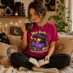 Woman sitting on a couch holding a mug, wearing the Hex Yeah Premium T-Shirt in berry