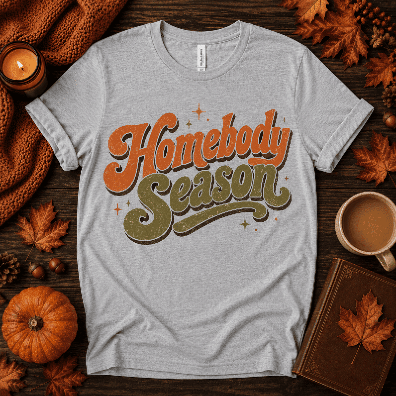 Homebody Season Premium T-Shirt in athletic heather gray, flat lay with autumn props