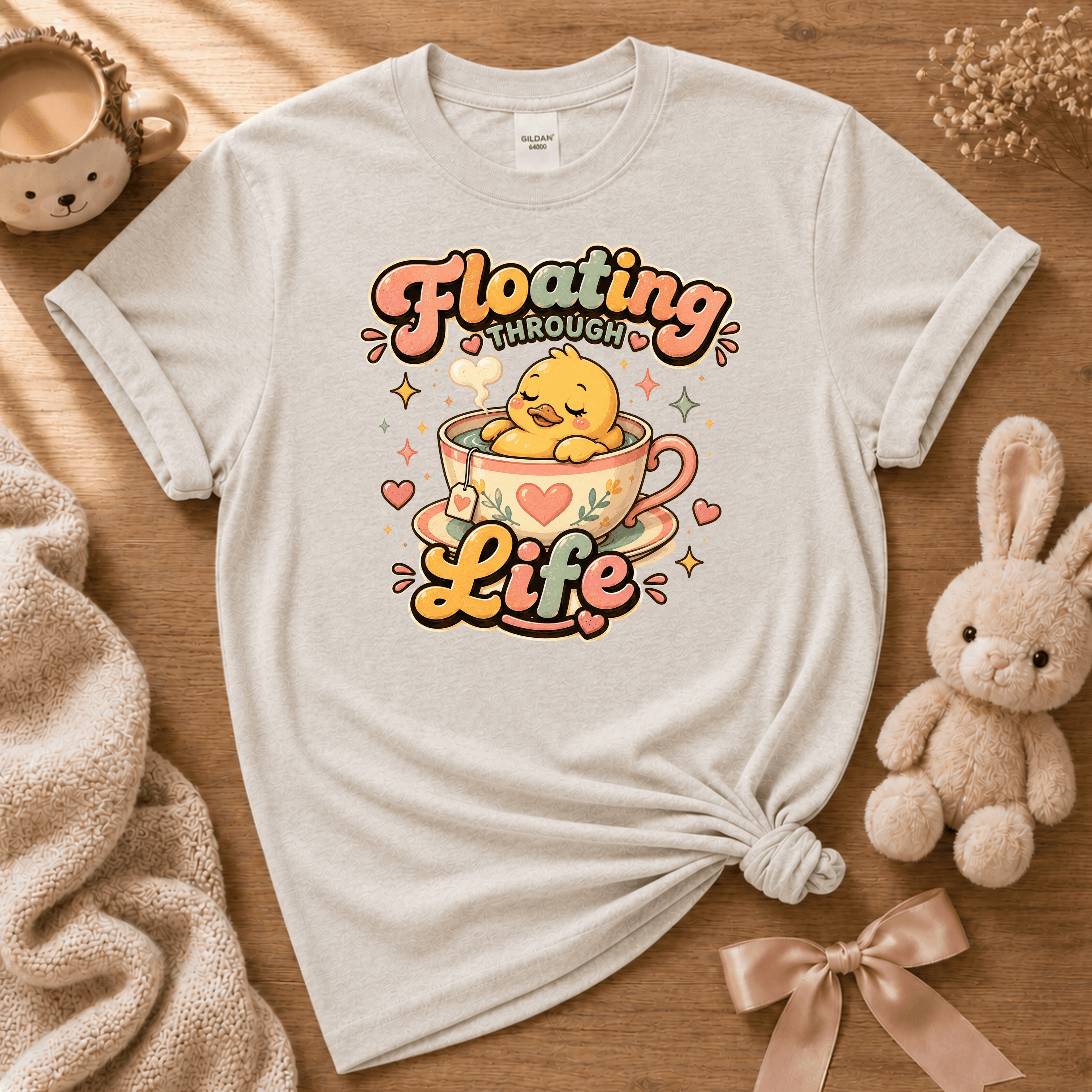 Floating Through Life cute animal graphic t-shirt displayed in a cozy flat lay in ice grey.