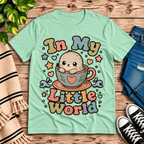 In My Little World Premium T-Shirt in mint, flat lay with cartoon seal in a teacup graphic