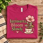Introverts Bloom Slowly Premium T-Shirt in berry, folded close-up with neck tag showing