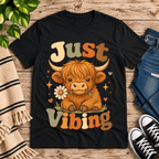 Just Vibing Cow Premium T-Shirt in vintage black, flat lay