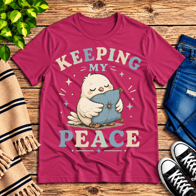 Keeping My Peace Premium T-Shirt in berry, flat lay with sleepy chick hugging a pillow graphic