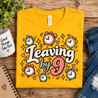 Leaving by 9 Premium T-Shirt in gold, folded close-up with neck tag showing