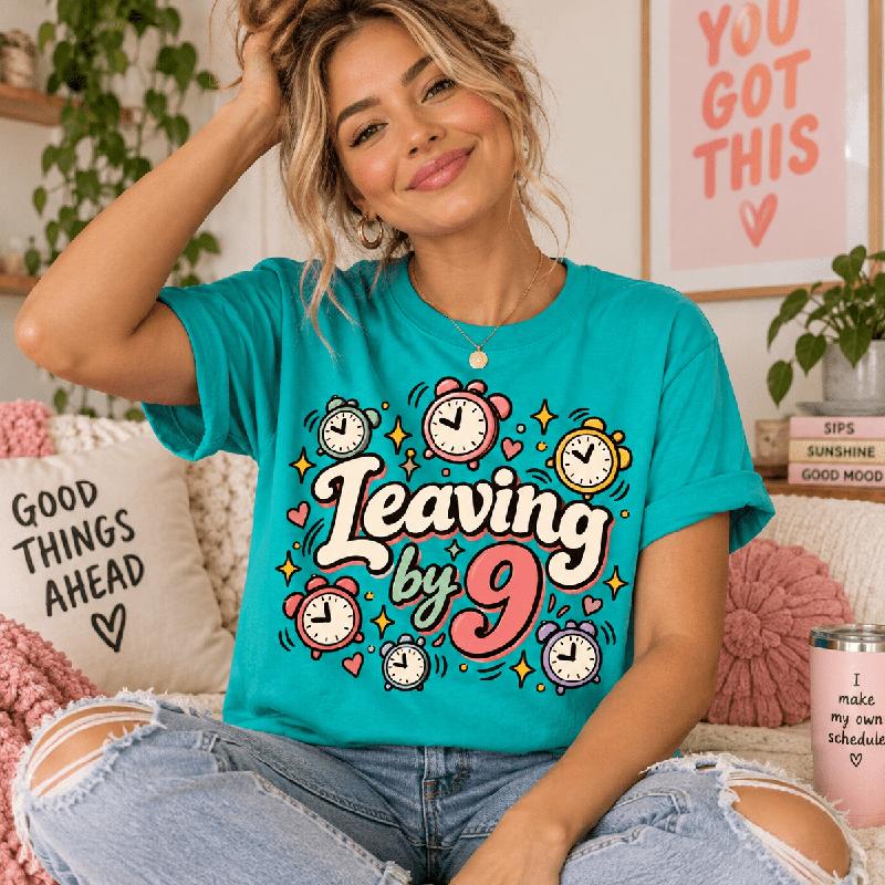 Woman sitting on a couch, wearing the Leaving by 9 Premium T-Shirt in heather sea green