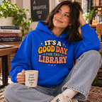 A woman wearing a royal blue It's A Good Day cute book graphic hoodie.
