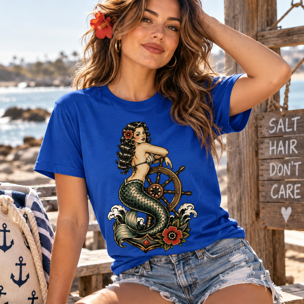 A woman wearing a true royal Ship Wheel Mermaid vintage pinup graphic t-shirt.