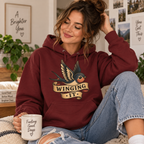 A woman wearing a burgundy Winging It cute animal graphic hoodie.