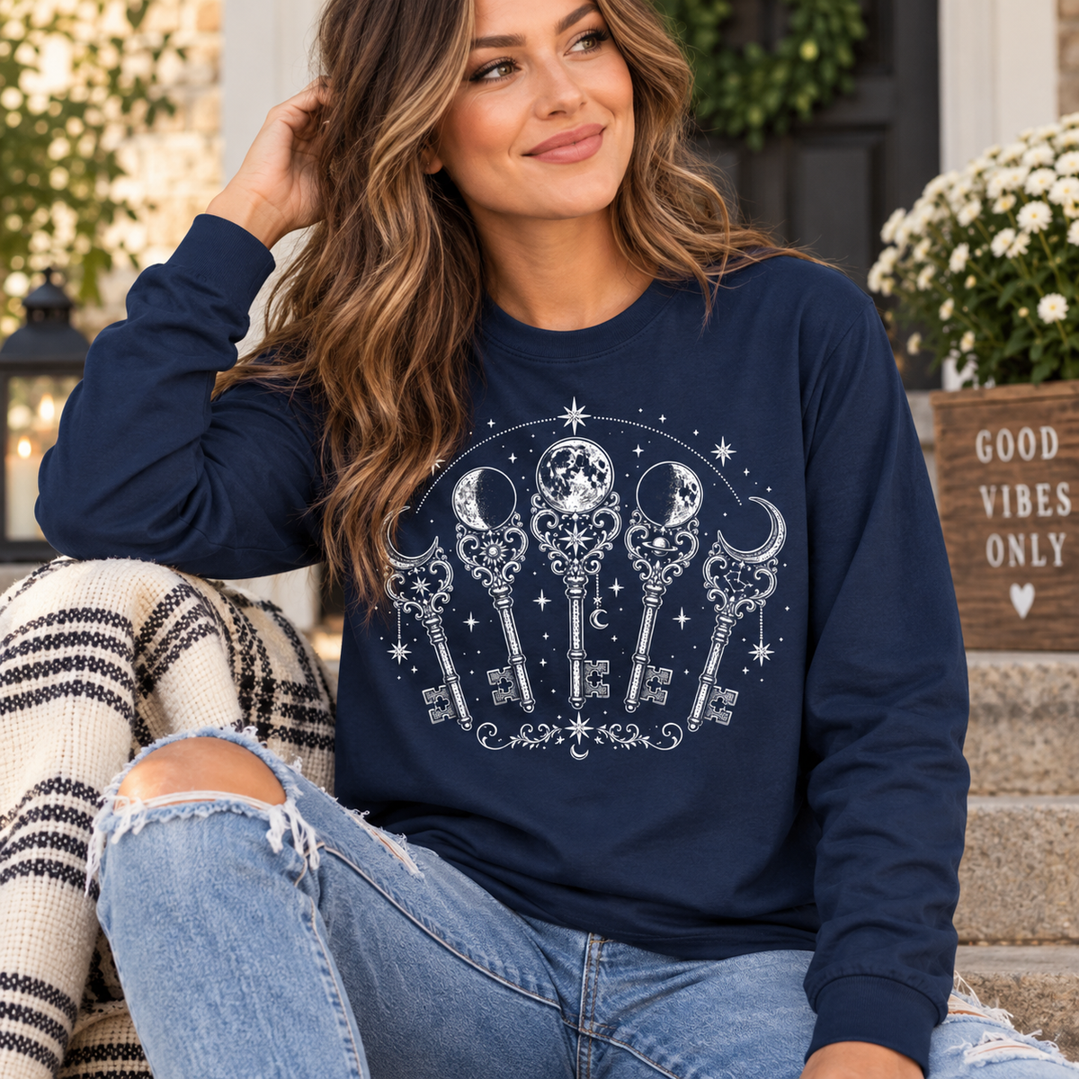 A woman wearing a j. navy Moon Phase Keys mystical graphic long sleeve.
