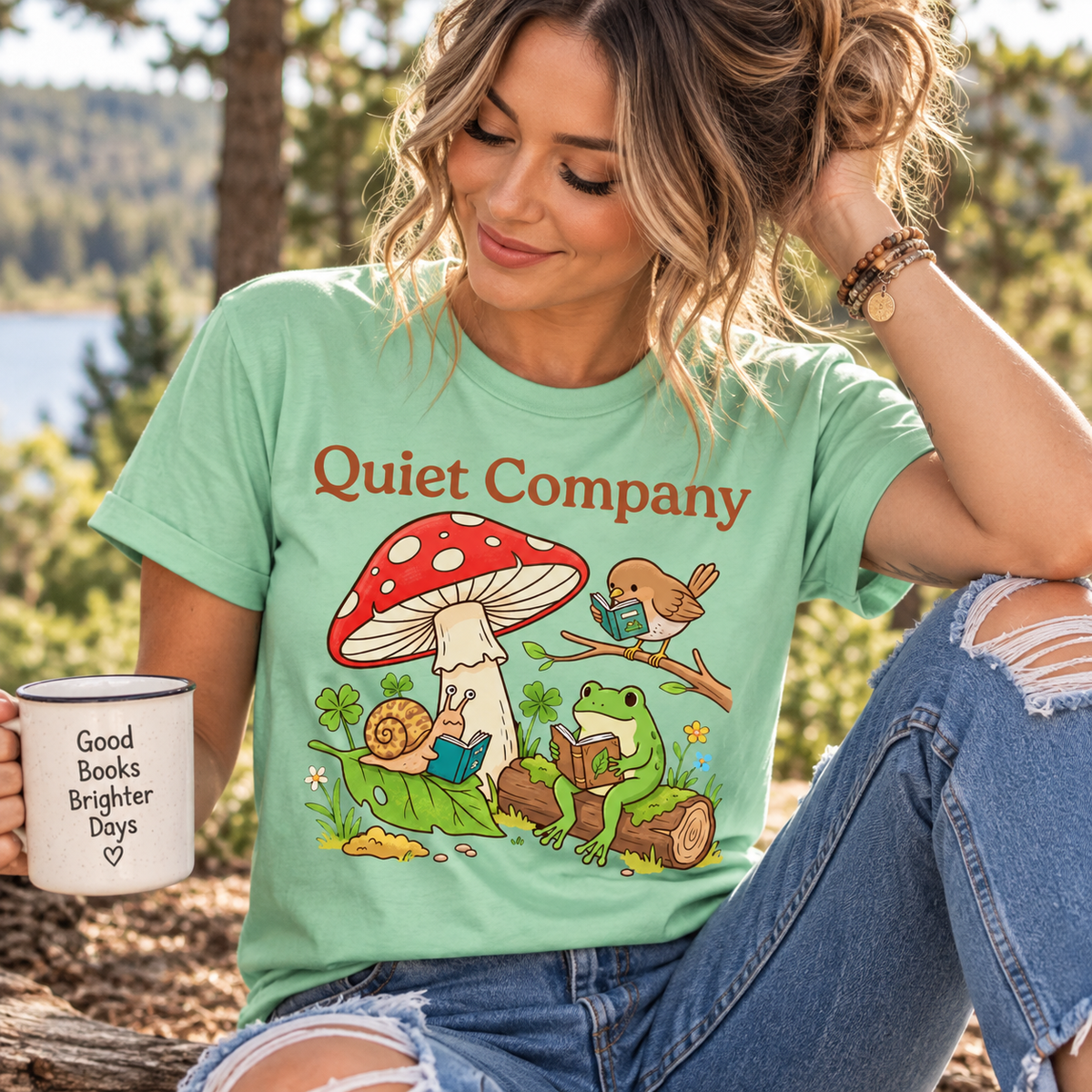 A woman wearing a mint Quiet Company cute cottagecore graphic t-shirt.