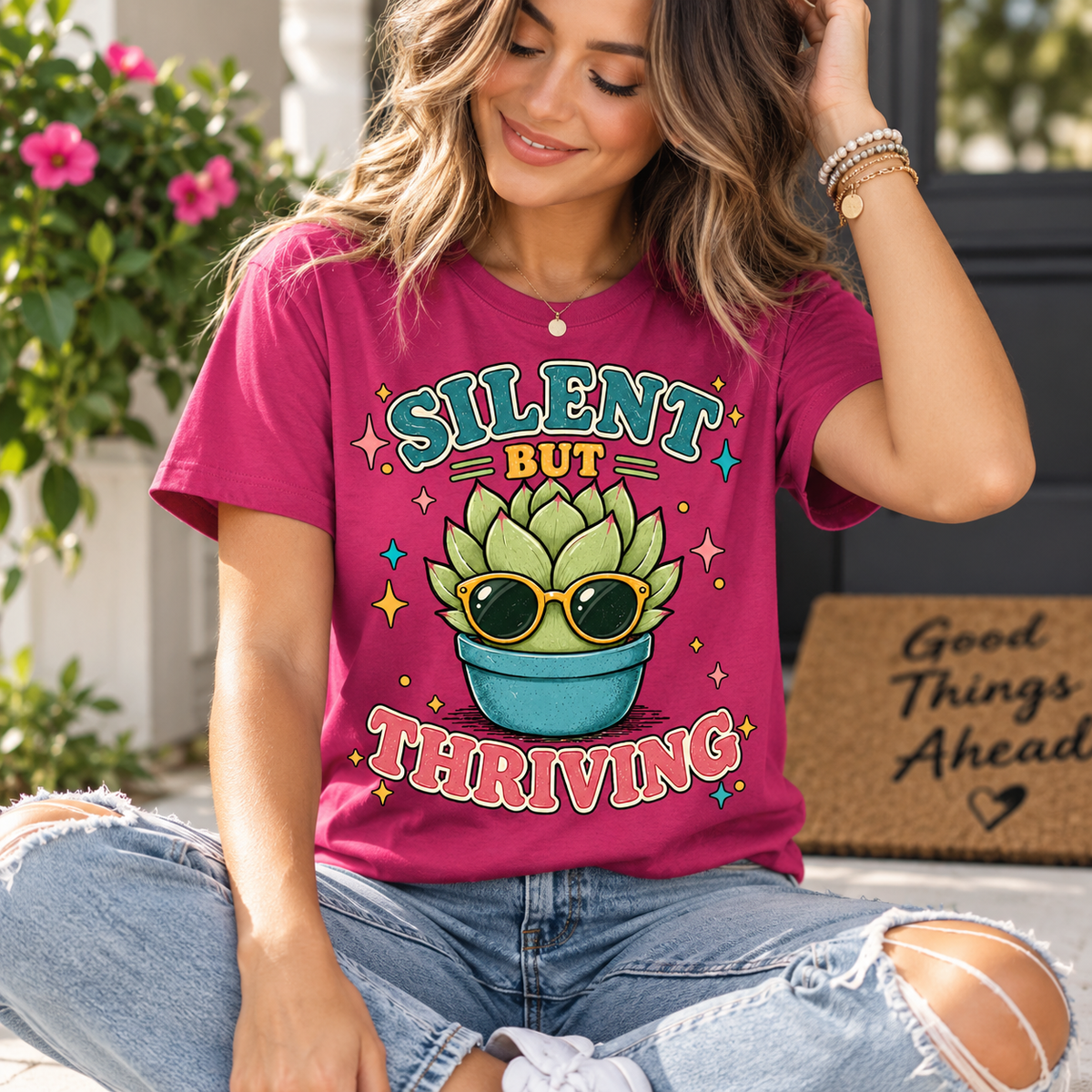 A woman wearing a berry Silent But Thriving cute plant graphic t-shirt.