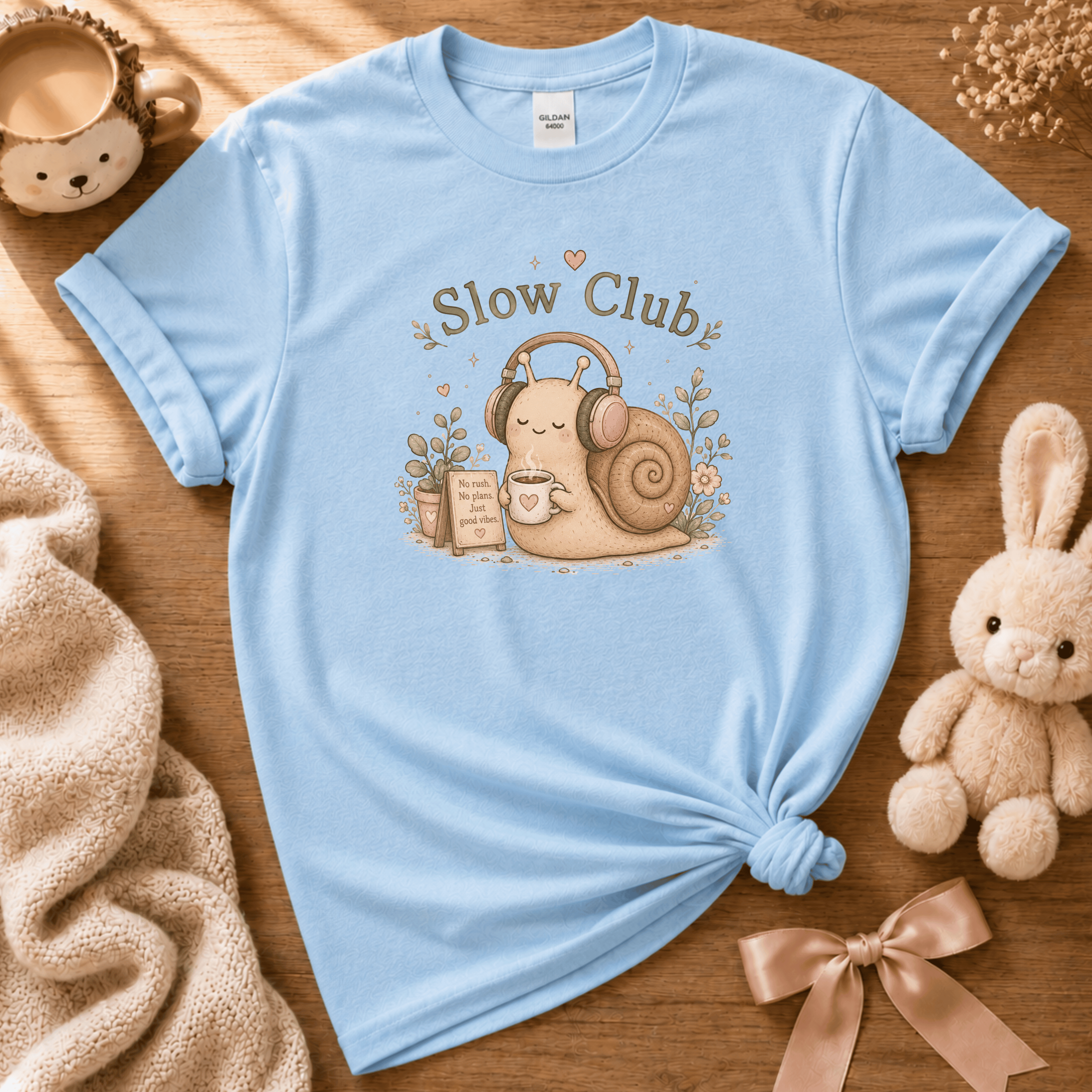 Slow Club cute animal graphic t-shirt in cozy flat lay in Light Blue.