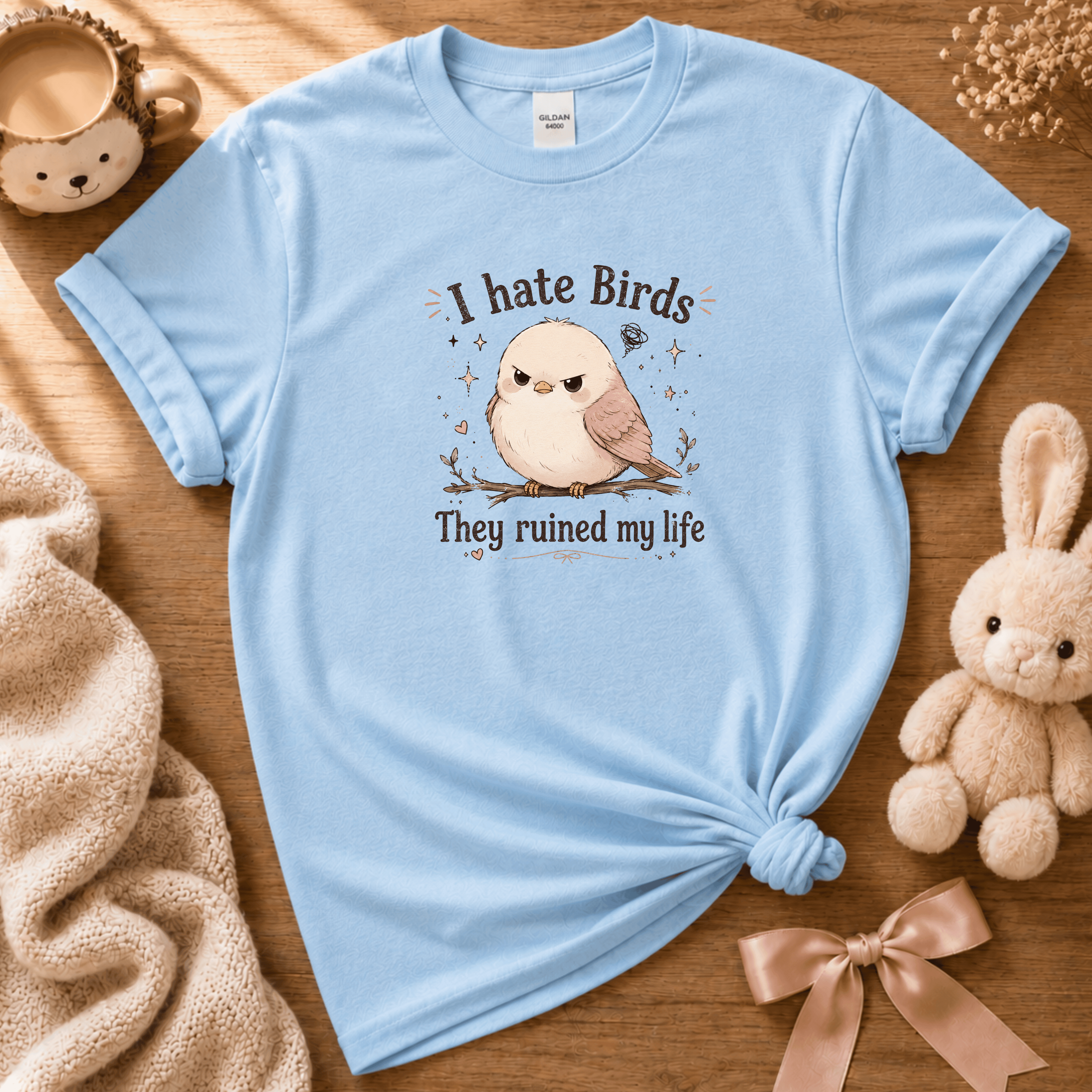 I Hate Birds cute animal graphic t-shirt cozy flat lay in light blue.