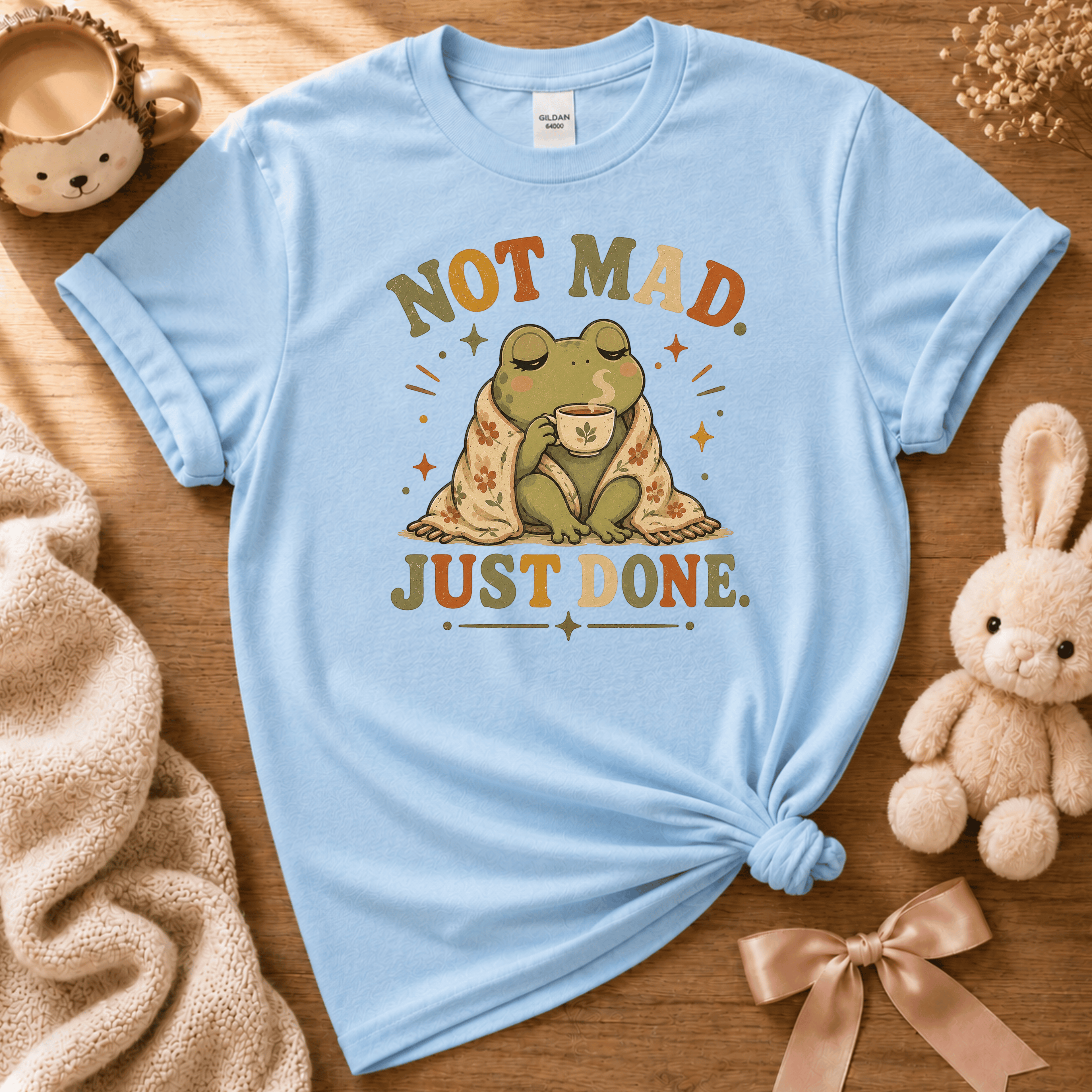 Just Done cute animal graphic t-shirt displayed in a cozy flat lay in light blue.
