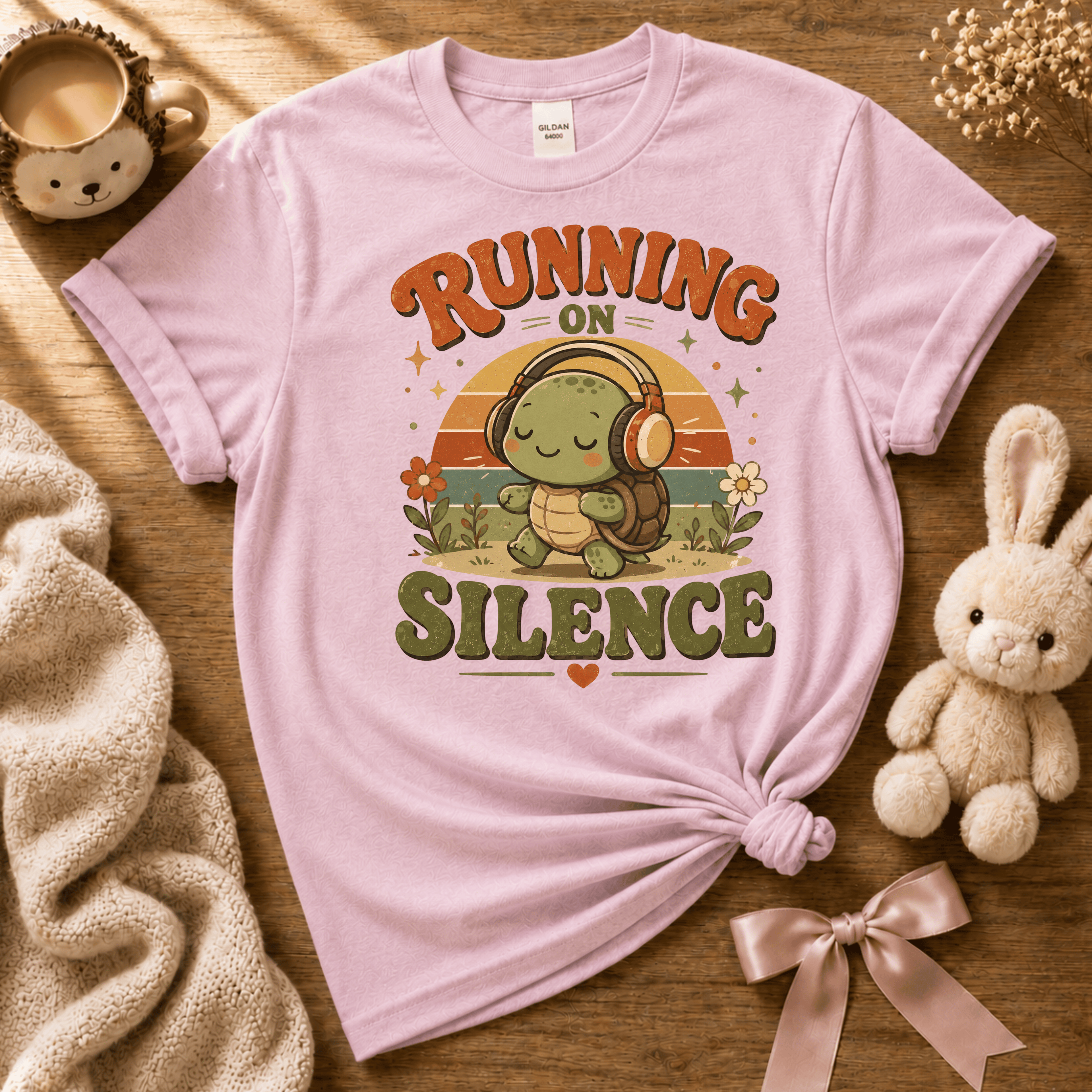 Running On Silence cute animal graphic t-shirt cozy flat lay in light pink.