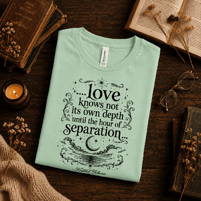 Love Knows Not Premium T-Shirt in mint, folded close-up styled with books and a candle