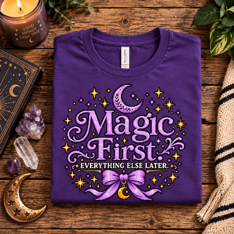 Magic First Premium T-Shirt in team purple, folded close-up with neck tag showing