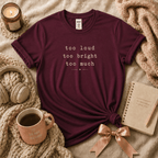 Too much introvert graphic t-shirt cozy flat lay in maroon.