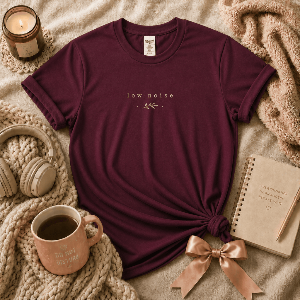 Low Noise introvert graphic t-shirt cozy flat lay in maroon.