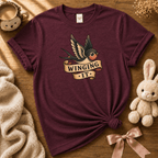 Winging it cute animal graphic t-shirt cozy flat lay in maroon.