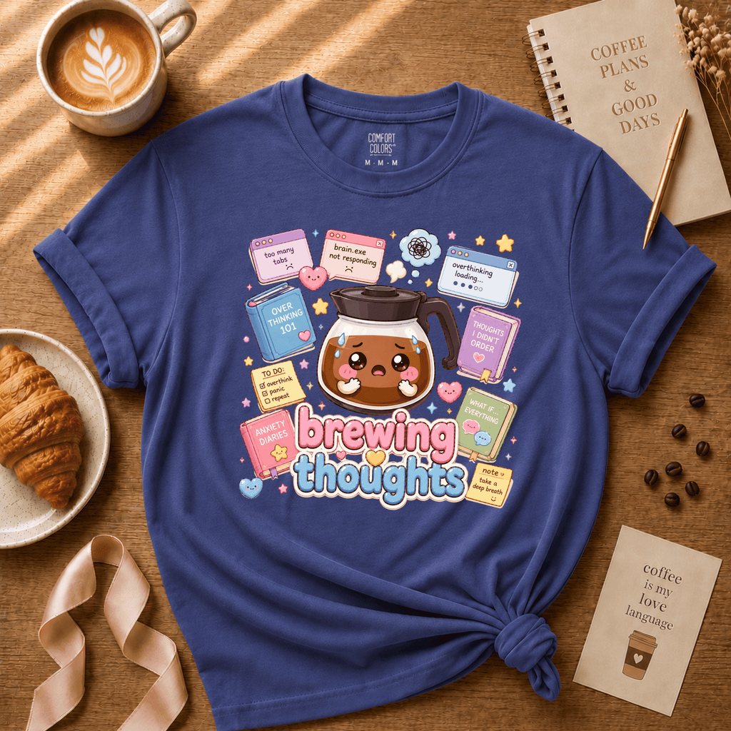 Brewing Thoughts coffee graphic t-shirt displayed in a cozy flat lay in metro blue.