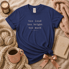 Too Much introvert graphic t-shirt cozy flat lay in metro blue.