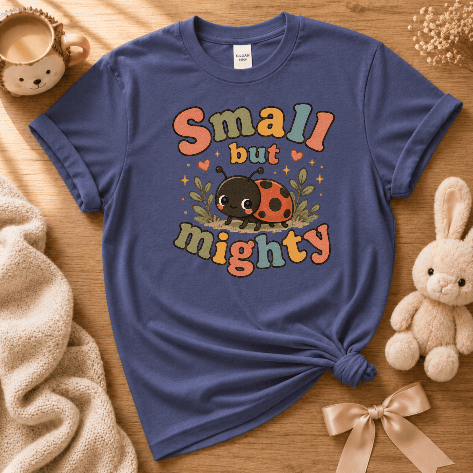 Small But Mighty cute animal graphic t-shirt cozy flat lay in metro blue.