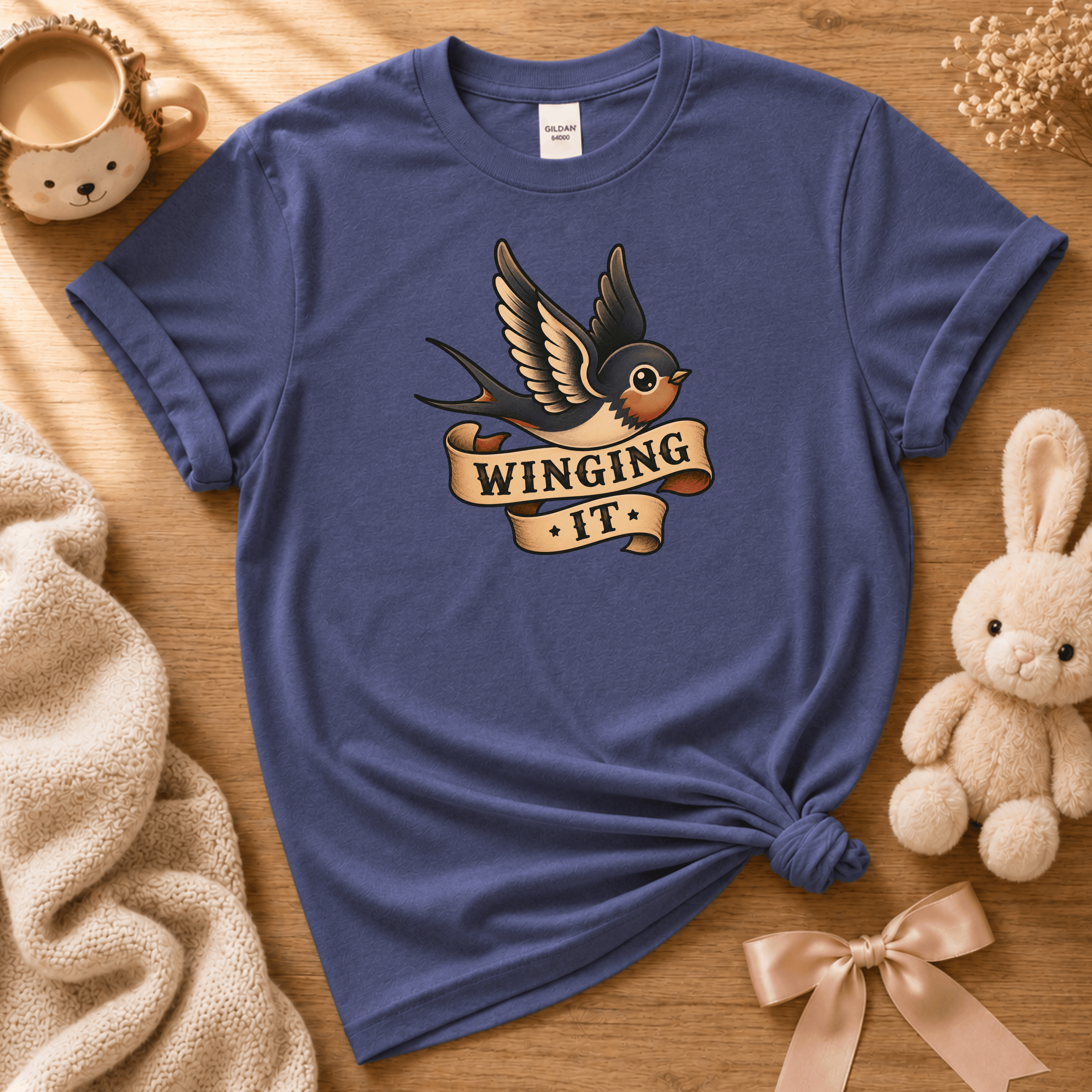 Winging it cute animal graphic t-shirt displayed in a cozy flat lay in metro blue.