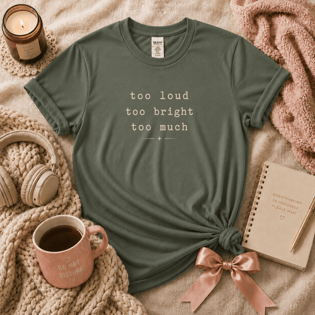 Too Much introvert graphic t-shirt cozy lay out in military green.