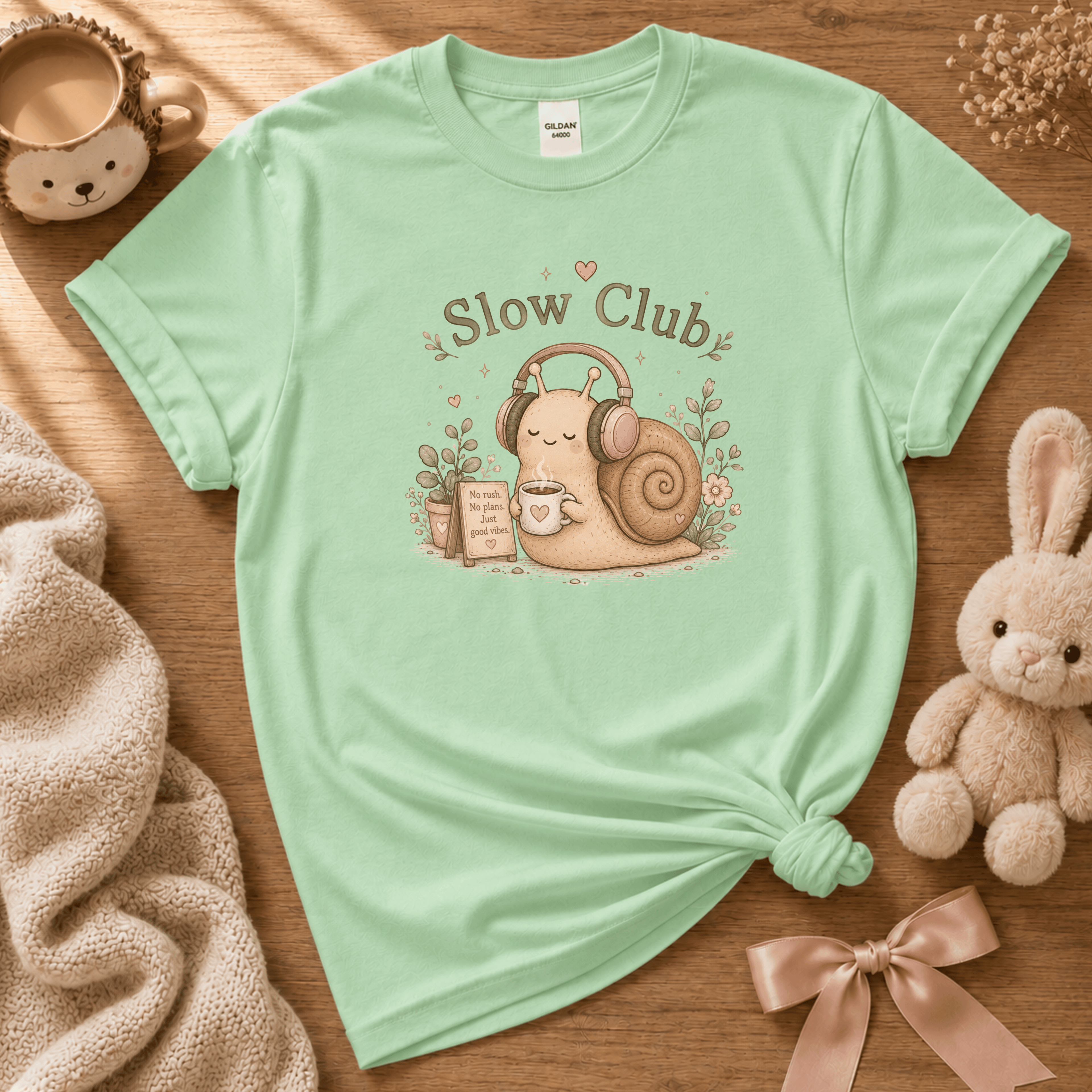 Slow Club cute animal graphic t-shirt cozy flat lay in mint green.